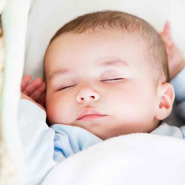 baby in a portable cot square