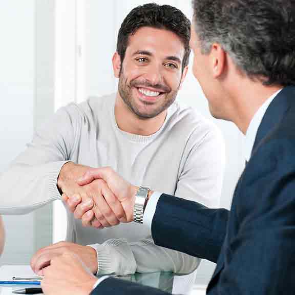 couple shake hands with man square