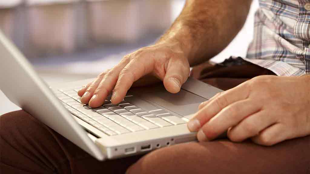 hands typing on a laptop computer